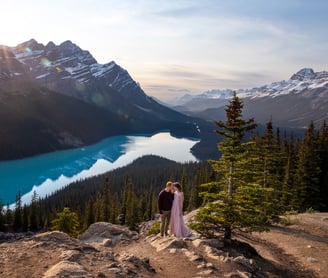 couple standing on a rock at peyto lake in Banff