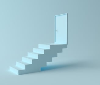 a white staircase leading to a door in air
