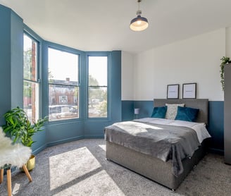 a bedroom with a bed and a chair