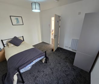 a bedroom with a bed and a lamp
