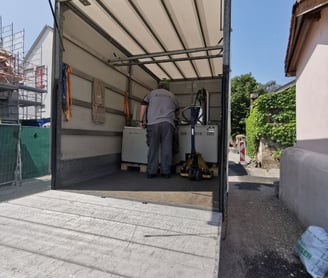 a man in a truck transporting a scanning electron microscope