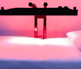 a red light therapy bed with a red heat lamp