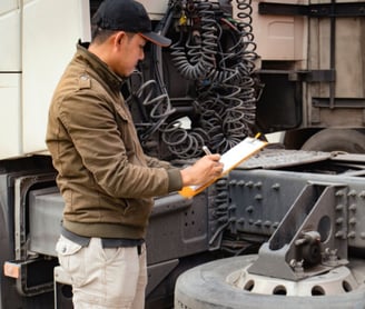 a man in a hat is standing in front of a truck