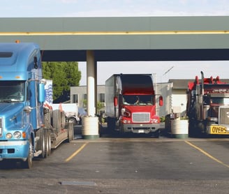 a truck with a semi truck parked in a parking lot