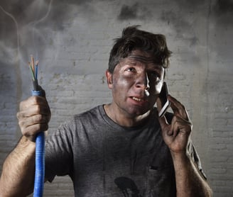 a man with aa man with a burned electrical cable and a smoky face after a fire