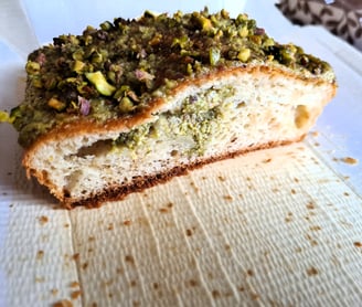 a piece of pistachio cake on the baking mold