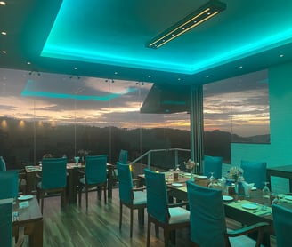 a dining room with a view of the sunset