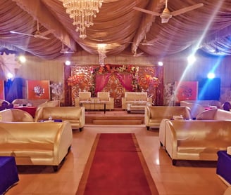 View of stage inside a big wedding hall decorated with lights and flowers