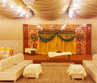 Marriage Hall Stage decorated with flowers and lights