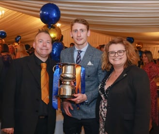 Elliott Hewitt receives the SSA Player of the Year 22/23 from Dean and Cheryl Foulkes