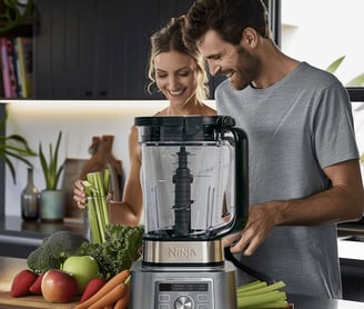 a man and woman standing in a kitchen