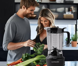 a man and woman standing in a kitchen