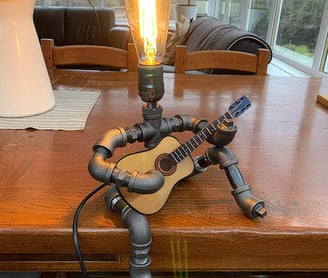 a guitar player steampunk is sitting on a table