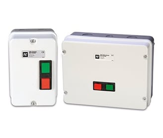 a white and green switch box with a red and green button