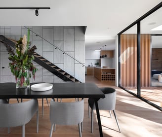 a dining room with a table and chairs