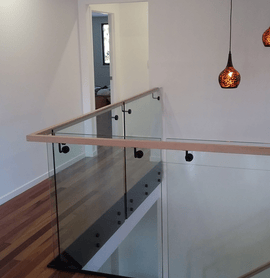 Glass balustrade with timber handrail 