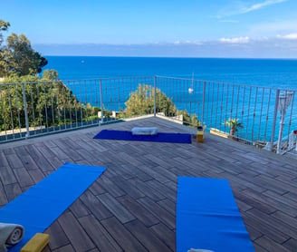 yoga class on terrace at hotel kalura in sicily facing the sea - yoga mats for asana