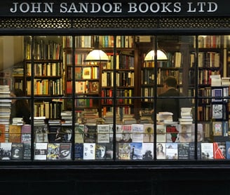 Books on Longevity - a book storefront window with a bookcase and a clock