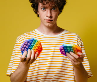 boy holding fidget toys.  ADHD Stimming