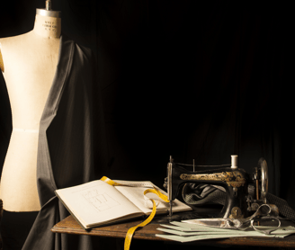 a sewing machine sitting on a table with a book and a sewing machine