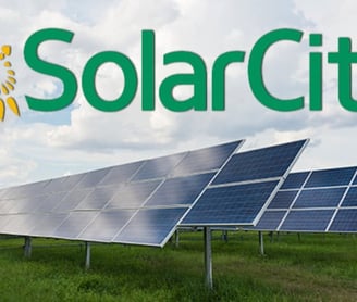 Solar City Logo Above Rows of Ground mounted solar panels.