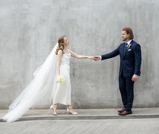 a bride and groom holding hands 