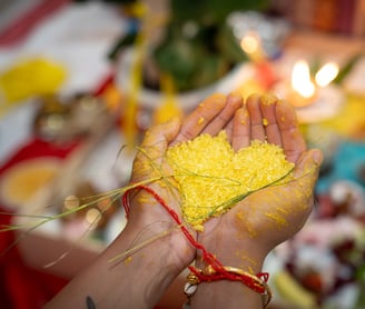 an India groom holding a heart shaped piece of rice