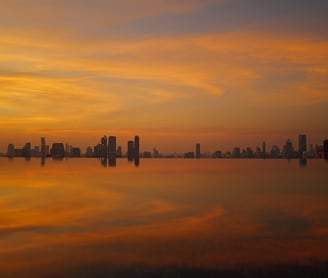Sunset city skyline of bangkok mirrored on calm water, By ACAT Photos