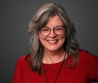 a woman with glasses and a red shirt