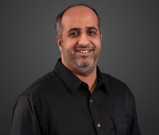 A man in a black button up shirt