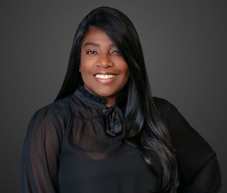 a woman with long black hair and a black blouse