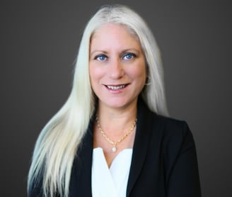 a woman with white hair and a black blazer