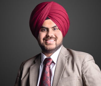 a man in a burgundy turban wearing a beige suit
