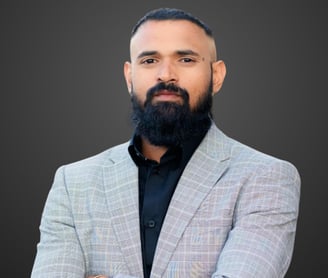 a man with a beard and grey suit