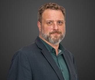 a man in a suit and green shirt