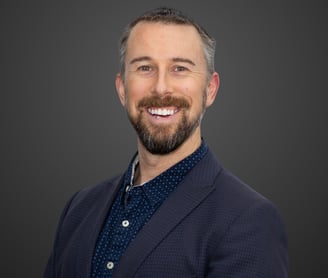 a man with a beard and navy suit