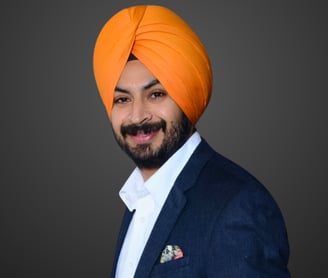 a man in an orange turban and navy suit