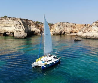 a sailboat in the water with a sailboat in the background