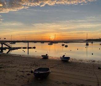 a boat is docked at a dock with boats in the water