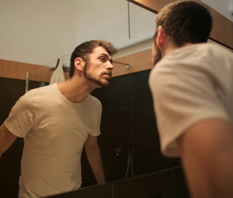 Man looking at himself in the mirror