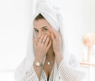 A woman applying eye cream