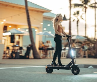 a woman riding a scooter in a city