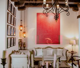 a living room with a red painting on the wall