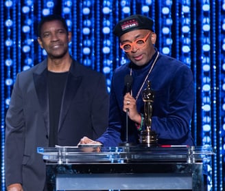 Oscar®-winning actor Denzel Washington (right center) present the Oscar® to Honorary Award recipient Spike Lee at the 2015 Go