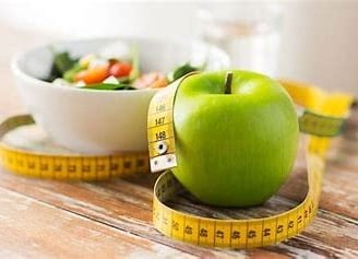 a green apple and a bowl of salad