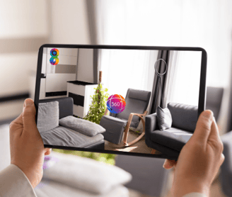 a person holding a tablet with a picture of a living room