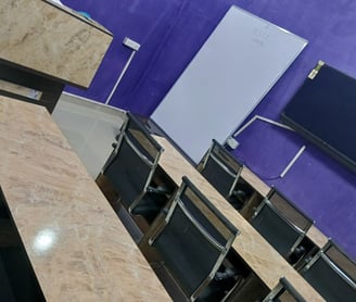 a room with a table and chairs and a television