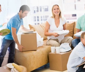 a family moving boxes in a living room