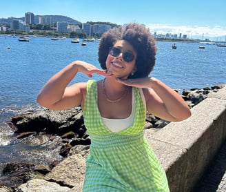 a woman in a green dress and sunglasses