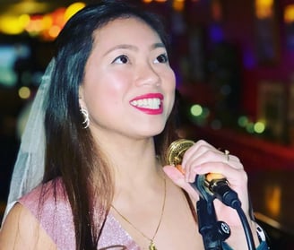 a woman in a tiaper veil and veil with a microphone